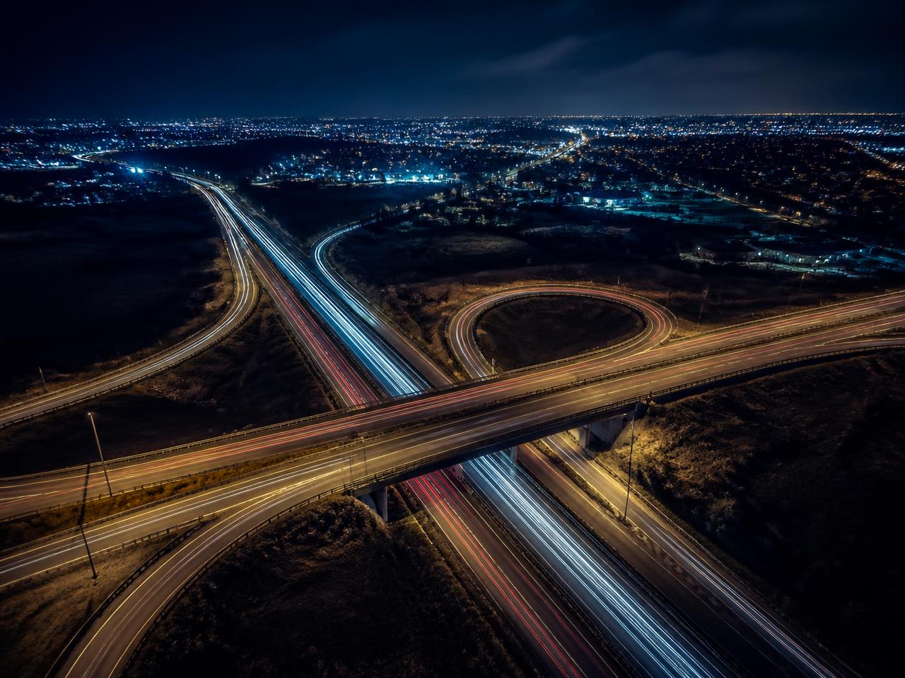 Night aerial view of an Irish motorway interchange with traffic light trails